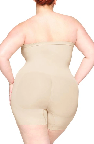 Shop Skims Seamless Sculpt Strapless Shortie Bodysuit In Sand