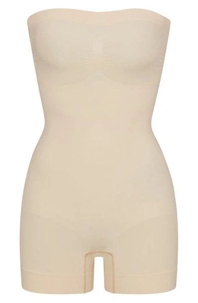 Shop Skims Seamless Sculpt Strapless Shortie Bodysuit In Sand