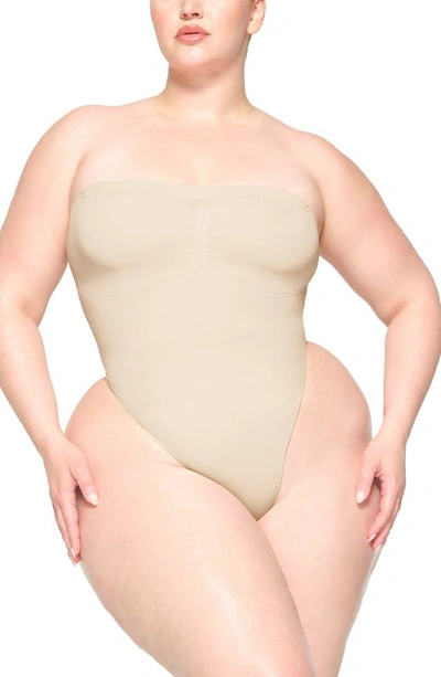 Shop Skims Seamless Sculpt Strapless Bodysuit In Sand