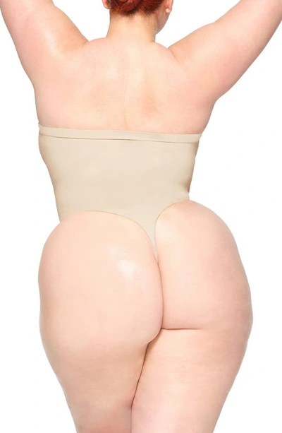 Skims Seamless Sculpt Strapless Bodysuit In Sand