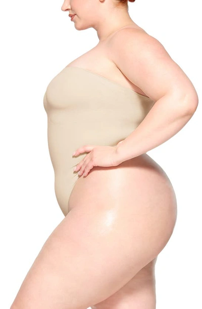 Skims Seamless Sculpt Strapless Bodysuit In Sand