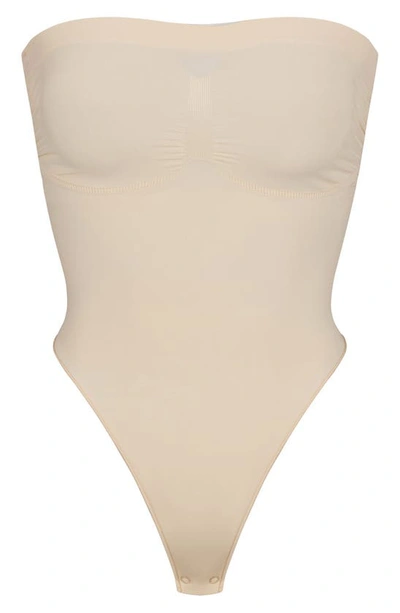 Skims Seamless Sculpt Strapless Bodysuit In Sand