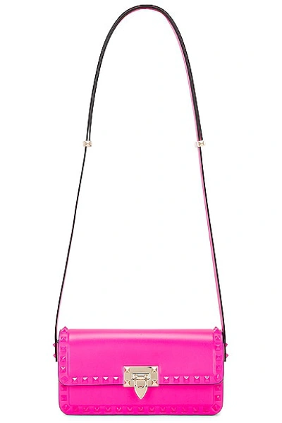 Shop Valentino East West Rockstud Shoulder Bag In Pink