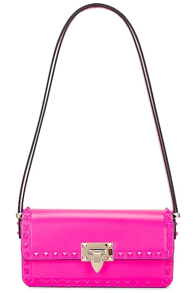 Shop Valentino East West Rockstud Shoulder Bag In Pink