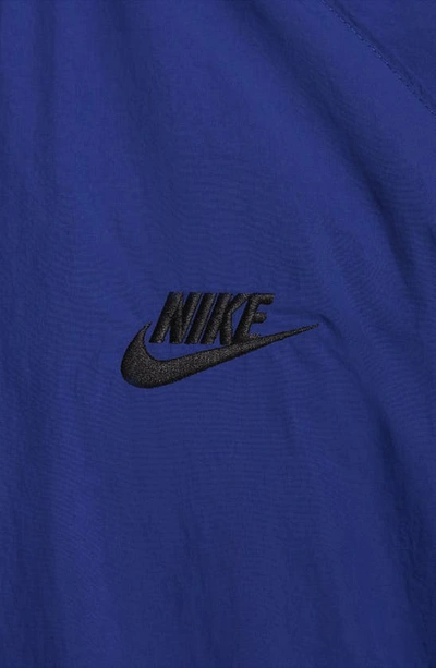 Shop Nike Club Water Repellent Woven Crewneck Windshirt In Deep Royal Blue/ Black