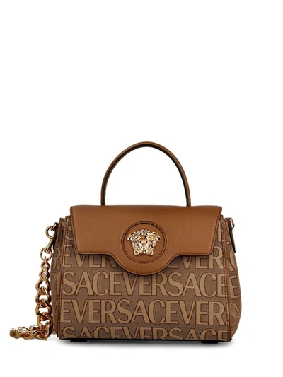 Shop Versace Handbags In Brown Beige
