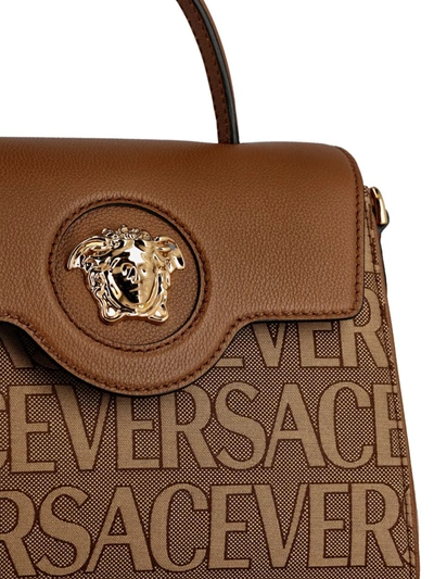 Shop Versace Handbags In Brown Beige