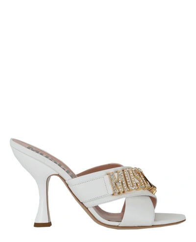 Shop Moschino Crystal Logo Leather Mules In White