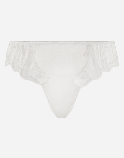 Shop Dolce & Gabbana Satin Thong With Lace Detailing In White