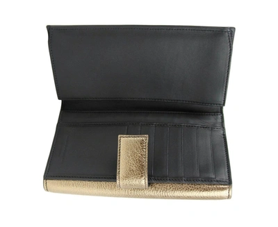 Alexander Mcqueen Women's Gold Metallic Leather Flap With Skull Wallet In Gold