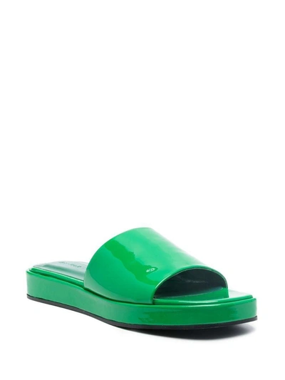 Shop By Far Cala Patent-finish Mules In Green