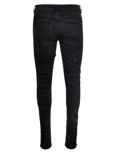 Shop Amiri Black Skinny Jeans With Crystal Embellished Logo And Used Effect In Stretch Cotton Denim Man