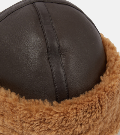 Shop Totême Shearling-trimmed Leather Hat In Brown