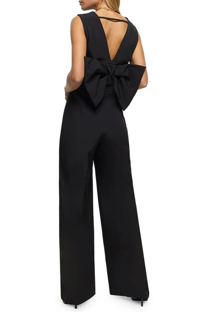 Shop River Island Back Bow Sleeveless Jumpsuit In Black