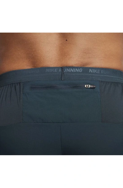 Shop Nike Dri-fit Stride 5-inch Running Shorts In Deep Jungle/ Luminous Green