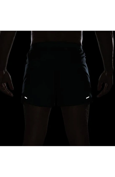 Shop Nike Dri-fit Stride 5-inch Running Shorts In Deep Jungle/ Luminous Green