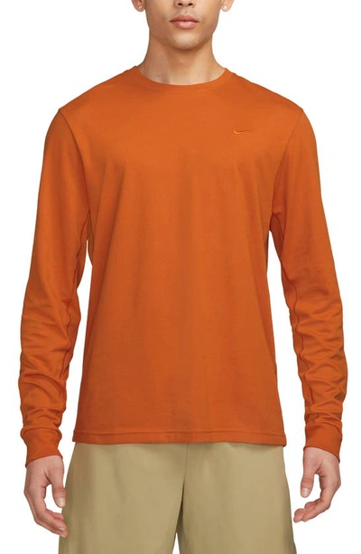 Shop Nike Dri-fit Primary Long Sleeve T-shirt In Campfire Orange