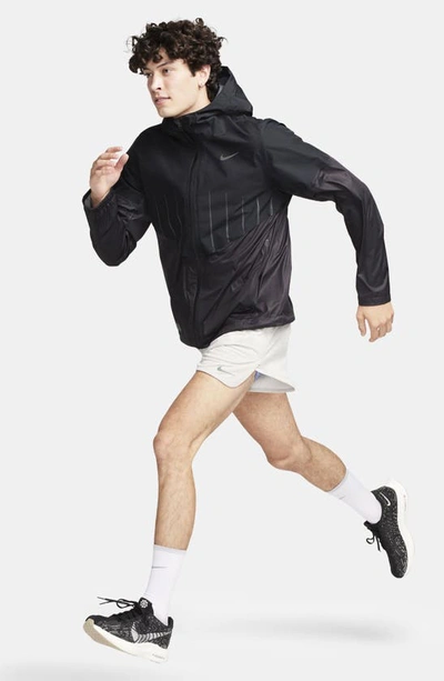 Shop Nike Run Division Aerogami Waterproof Hooded Running Jacket In Black