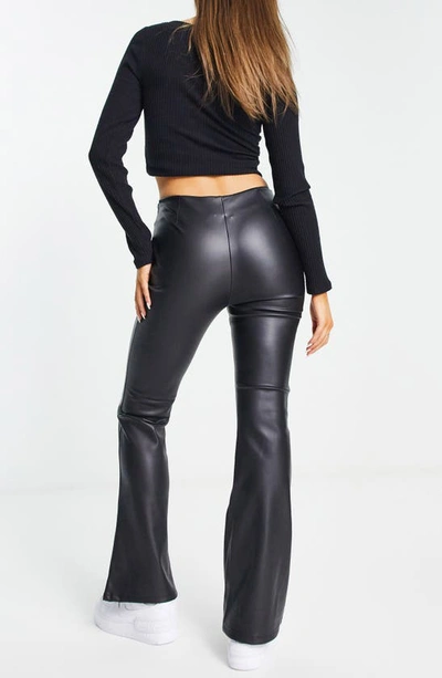Shop Asos Design Faux Leather Flare Leg Pants In Black