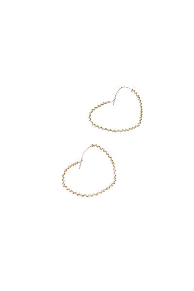 A Blonde And Her Bag Wrapped Around The Heart Earring In Silver With Gold Wrap In Gold