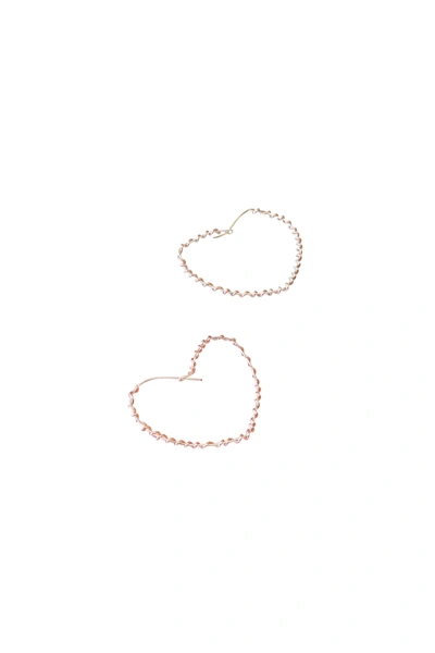 A Blonde And Her Bag Wrapped Around The Heart Earring In Silver With Rose Gold Wrap In Gold