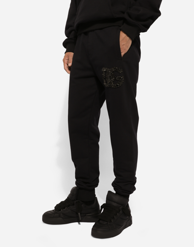 Shop Dolce & Gabbana Jogging Pants With Rhinestone-detailed Dg Patch In Black