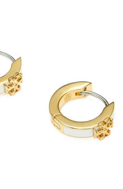 Shop Tory Burch Kira Enamel Huggie Earrings In Tory Gold / New Ivory