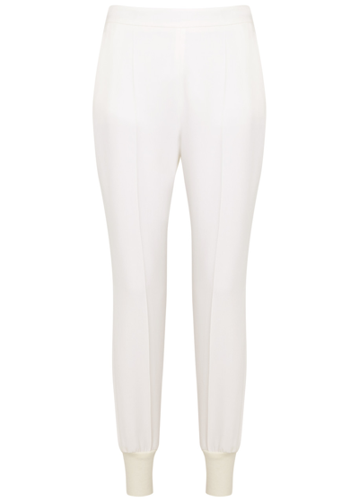 Shop Stella Mccartney Tapered Stretch-crepe Trousers In White