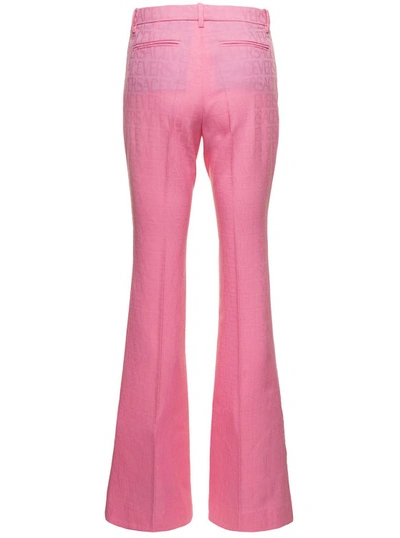 Shop Versace Pink Flare Pants With Tonal Logo Lettering In Wool