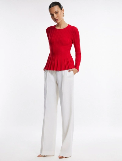 Shop Bcbgmaxazria Long Sleeve Rib Peplum Knit Top In Fiery Red