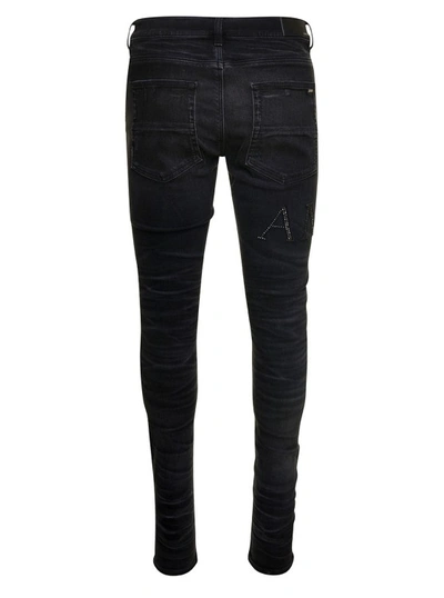 Shop Amiri Black Skinny Jeans With Crystal Embellished Logo And Used Effect In Stretch Cotton Denim