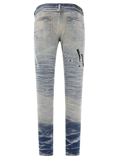 Shop Amiri "staggered Logo" Jeans In Blue