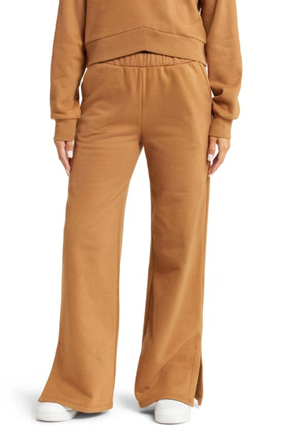 Shop Beyond Yoga On The Go Wide Leg Flare Pants In Toffee