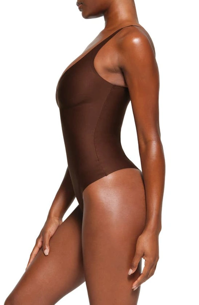 Shop Skims Body Plunge Thong Shaper Bodysuit In Cocoa