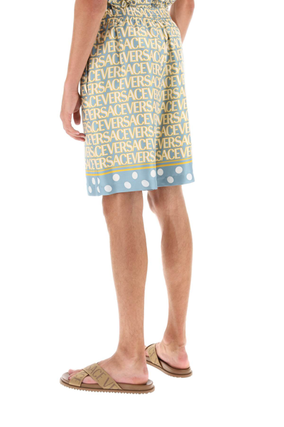 Versace Silk Bermuda Shorts With All-over Logo In Light Blue Ivory