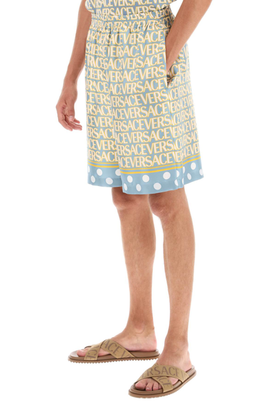 Versace Silk Bermuda Shorts With All-over Logo In Light Blue Ivory