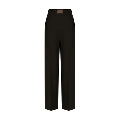 Shop Dolce & Gabbana Flared Wool Pants With Logo Tag In Black