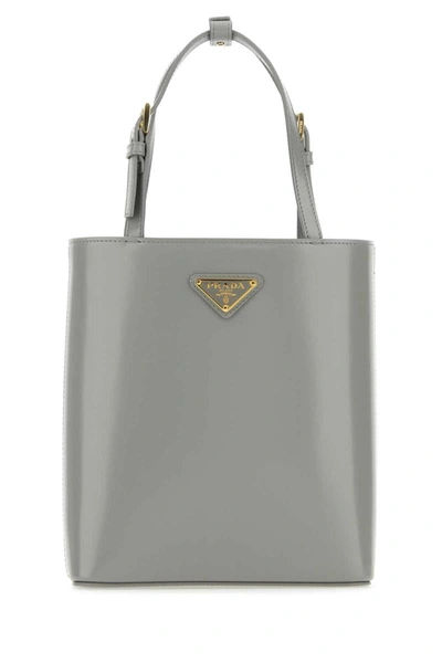 Shop Prada Handbags. In Grey