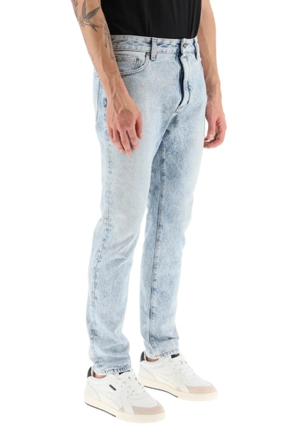 Shop Palm Angels Slim Fit Acid Wash Jeans With Rear Curved Logo Print