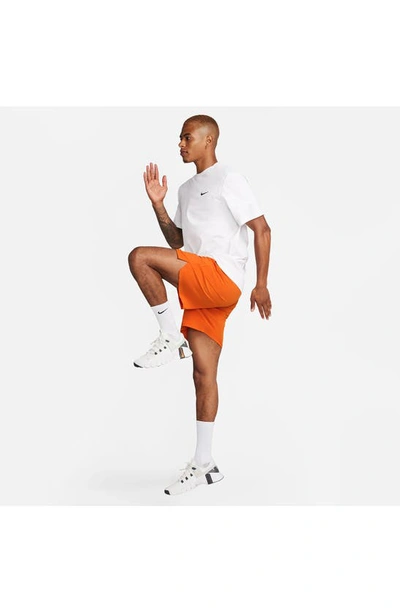 Shop Nike Dri-fit Unlimited 7-inch Unlined Athletic Shorts In Campfire Orange