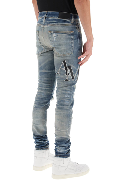 Shop Amiri Destroyed Jeans With Staggered Logo Men In Blue
