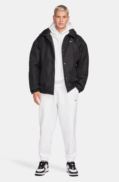 Shop Nike Solo Swoosh Water Repellent Puffer Jacket In Black/ White