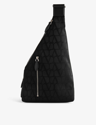 Shop Valentino Garavani Nero Vlogo Monogram-pattern Woven Sling Bag