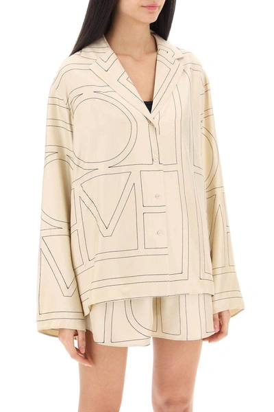 Shop Totême Toteme Monogram Silk Pajama Shirt In Beige