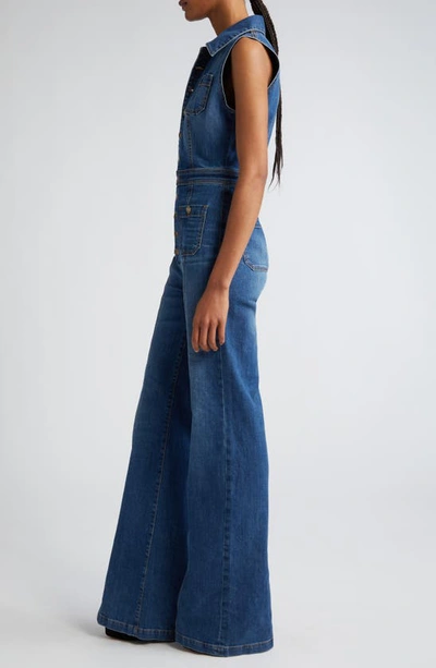 Shop Ramy Brook Carly Flared Denim Jumpsuit In Medium Wash