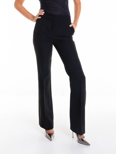 Shop Moschino Flared Pants In Black