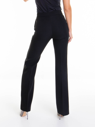 Shop Moschino Flared Pants In Black