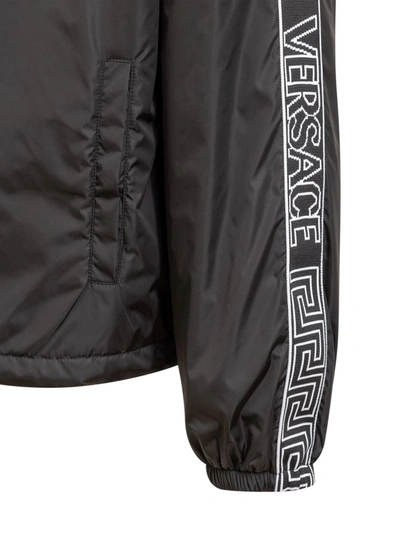 Shop Versace Hooded Windbreaker Jacket In Black