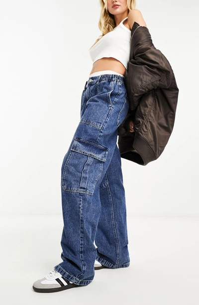 Shop Asos Design Wide Leg Cargo Jeans In Mid Blue