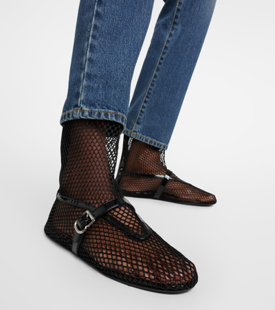 Shop Alaïa Fishnet Leather-trimmed Ankle Boots In Black